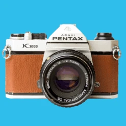 Pentax K1000 Brown Leather Vintage SLR 35mm Film Camera With Pentax F/2 50mm Prime Lens.